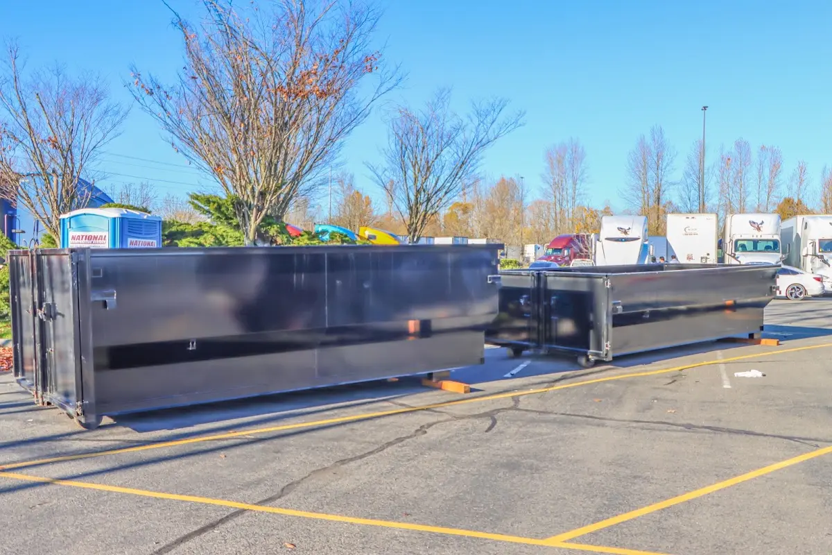 Professional dumpster rental service with roll-off container on residential driveway in West Hollywood